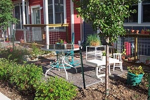 Holiday Neighborhood home: red with white trim and raised deck.