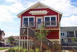 Holiday Neighborhood home: red with white trim and raised deck.