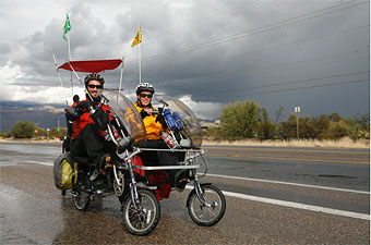 Ryan Mlynarczyk and Mandy Creighton of Within Reach as they pedal down a rainy Tucson, Ariz. street.