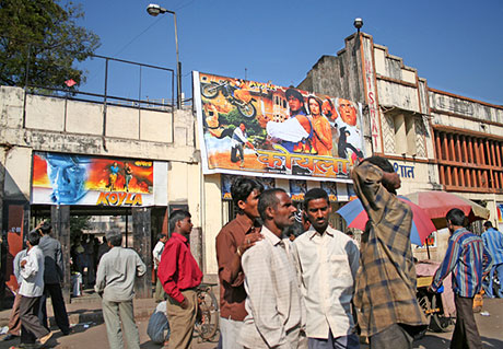 Men outside Bollywood cinema house.