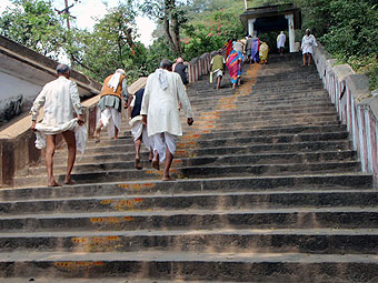 Barefoot pilgrims climb steps.