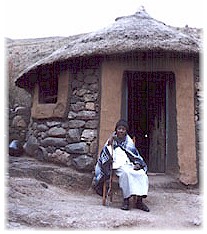A chieftainess in front of her home.