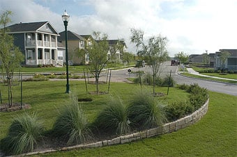 A roundabout and Austin vernacular architecture at Plum Creek.