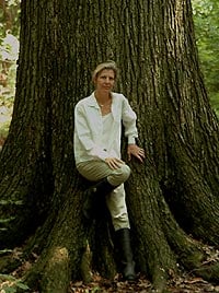 image, Joan Maloof next to old growth tree.