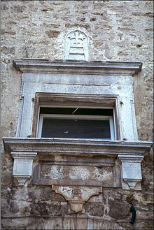 The Santa Maria della Scala symbol in the granary village of Serre di Rampolano. 