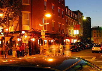 Boston's North End, intersection with lots of people at night.