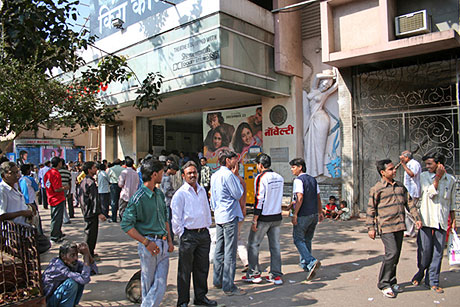 Men outside Bollywood cinema house.