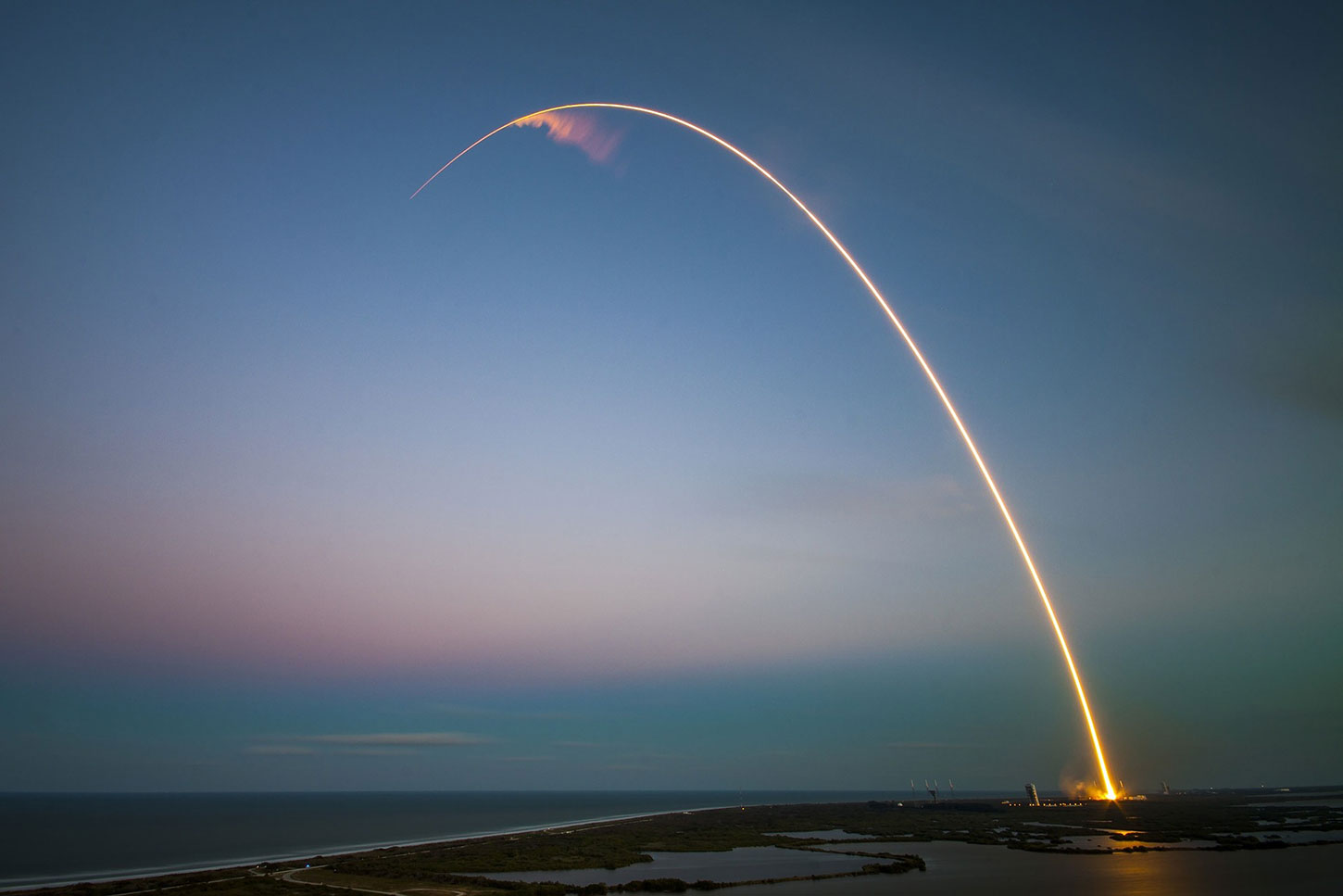 A rocket launching in a blue sky