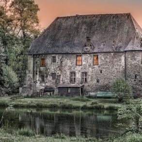 Old cottage among trees