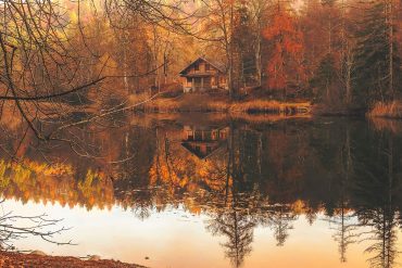 A cabin on a lake during Autumn