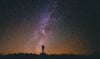 Silhouette of person under starry sky