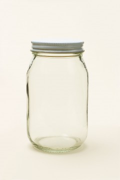 Empty glass jar on seamless color background