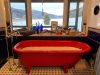 Bathtub with view of high country and mountains through windows