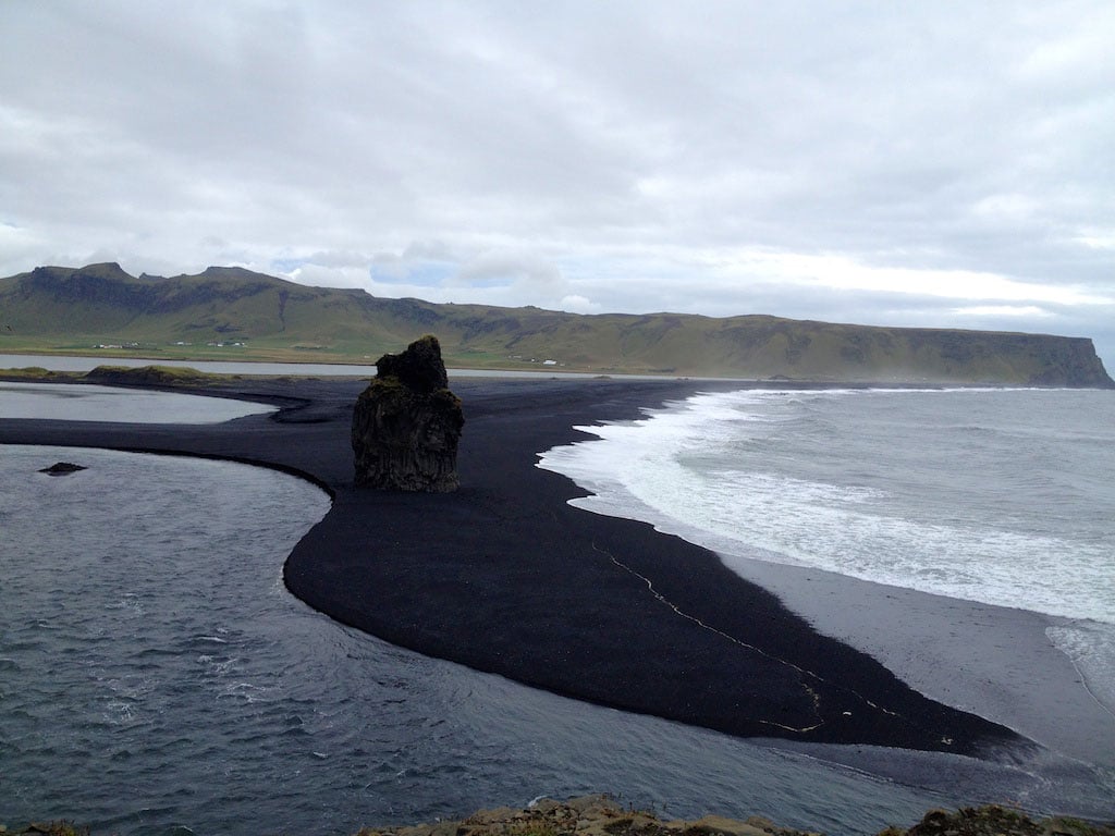 black sand beach reaching into the sea