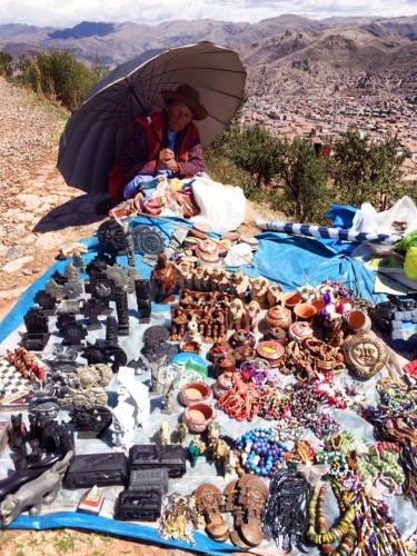 A Bolivian woman sells souvenirs over La Paz.