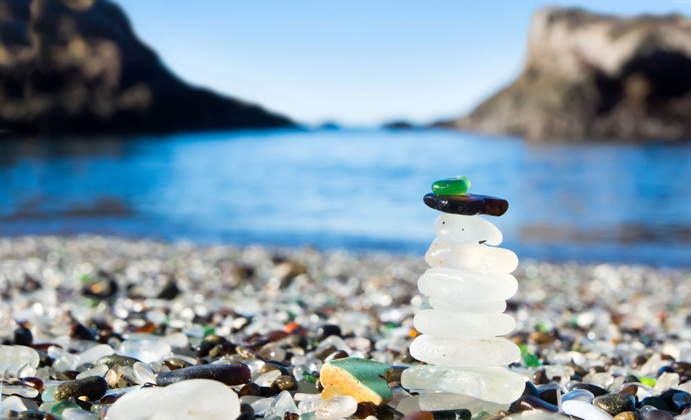 Photo of stacked sea glass at Glass Beach in Fort Bragg, California, courtesy Shutterstock.