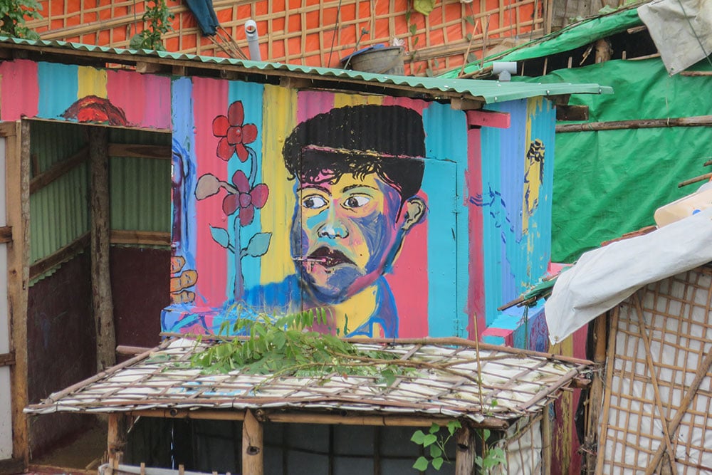 Colorful mural on shack in refugee camp