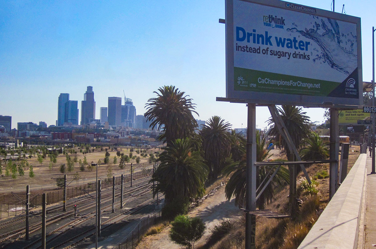 Downtown L.A. with billboard and train tracks.