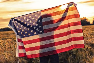 Silhouette of girl holding U.S. flag