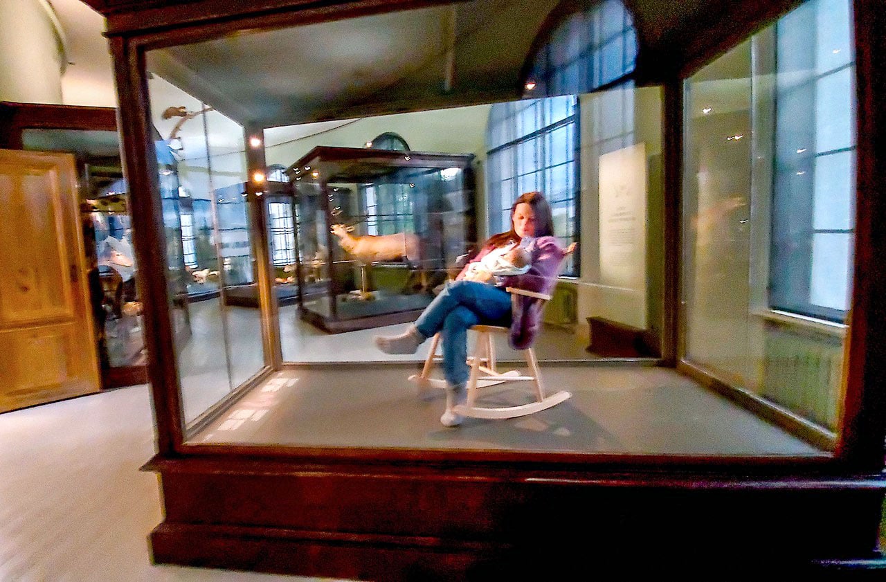 Display of woman nursing a baby in a case. Photo by David Rothenberg