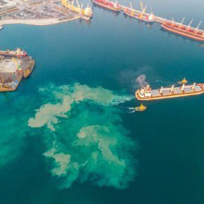 Aerial view of cargo ship leaving port