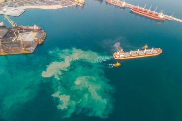 Aerial view of cargo ship leaving port
