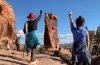 Women in desert raising fists