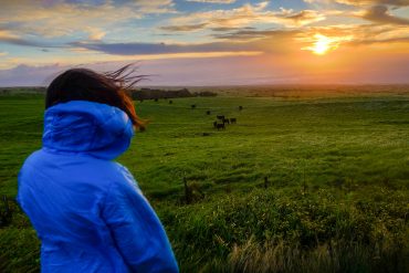 Garrett's daughter overlooking landscape at sunset