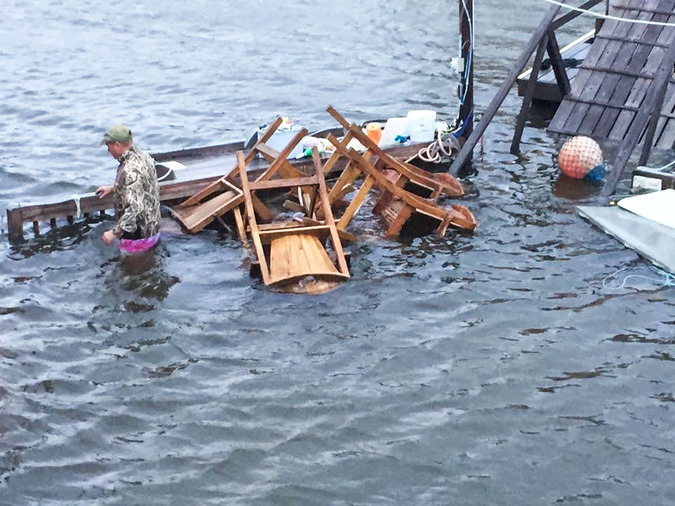 Furniture floating in water, with man