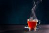 Steaming glass mug of tea
