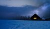 Snowy house with light window