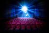 Movie theater with empty seats and projector light