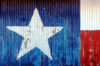 Texas flag painted onto corrugated metal and peeling