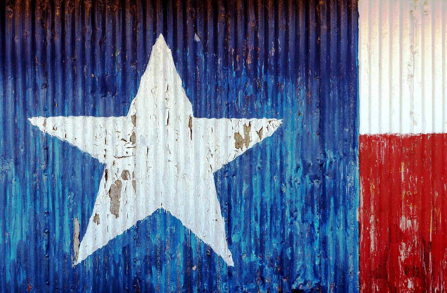Texas flag painted onto corrugated metal and peeling