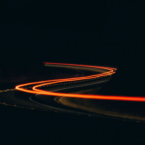 Taillights at night on winding road