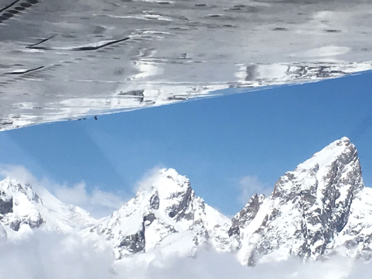 Aerial view of Grand Tetons and airplane wing