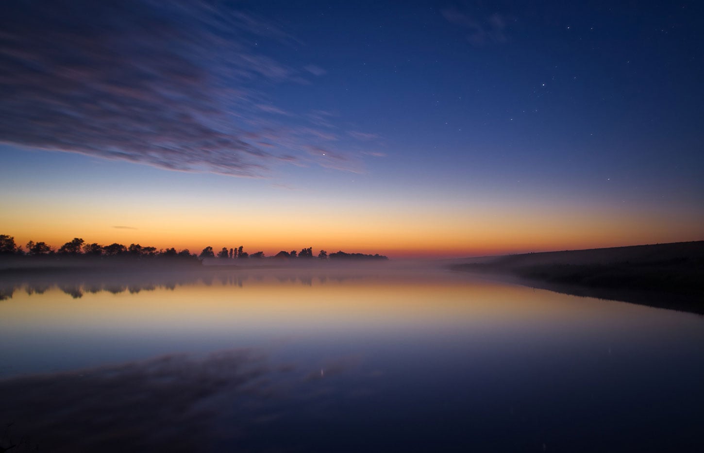 Twilight with stars over pond
