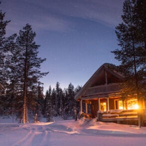 Lit cabin in snow