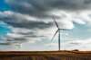 Wind turbines on prairie farm, with clouds