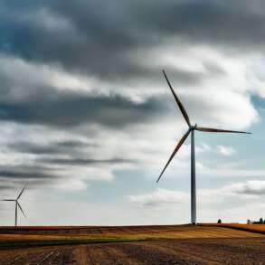 Wind turbines on prairie farm, with clouds