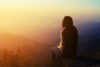 Soft silhouette of woman with early morning vista