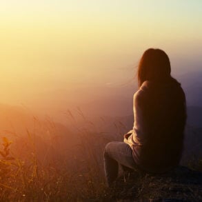 Soft silhouette of woman with early morning vista