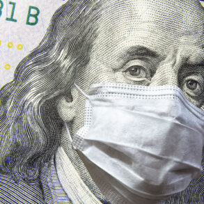 $100 bill with facemask on Ben Franklin