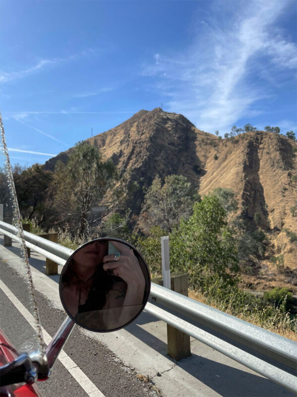 Side mirror, mountain, reflection of hand with ring