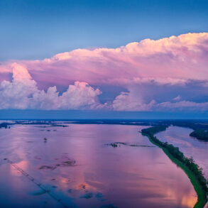 Flooded farmland with storm clouds at dusk