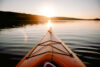 Sea kayak pointed into sunset over islands