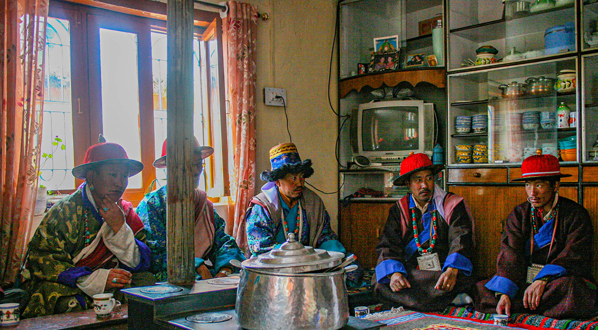 Guests at a wedding in Kaza share chang, a local alcoholic brew made from barley