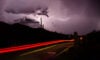Desert at night, lightning, car taillights