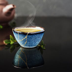 Kintsugi cup with tea and teapot