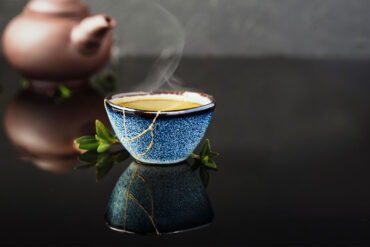 Kintsugi cup with tea and teapot